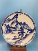 A PAIR OF CHINESE BLUE AND WHITE CHARGERS PAINTED WITH MOUNTAINOUS ISLANDS, A BUFFALO ON ONE AND A