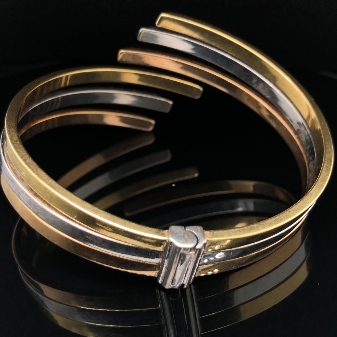 AN ITALIAN THREE COLOUR GOLD SPRUNG HINGED CONTEMPORARY BANGLE. STAMPED 750, ASSESSED AS 18ct - Image 2 of 3