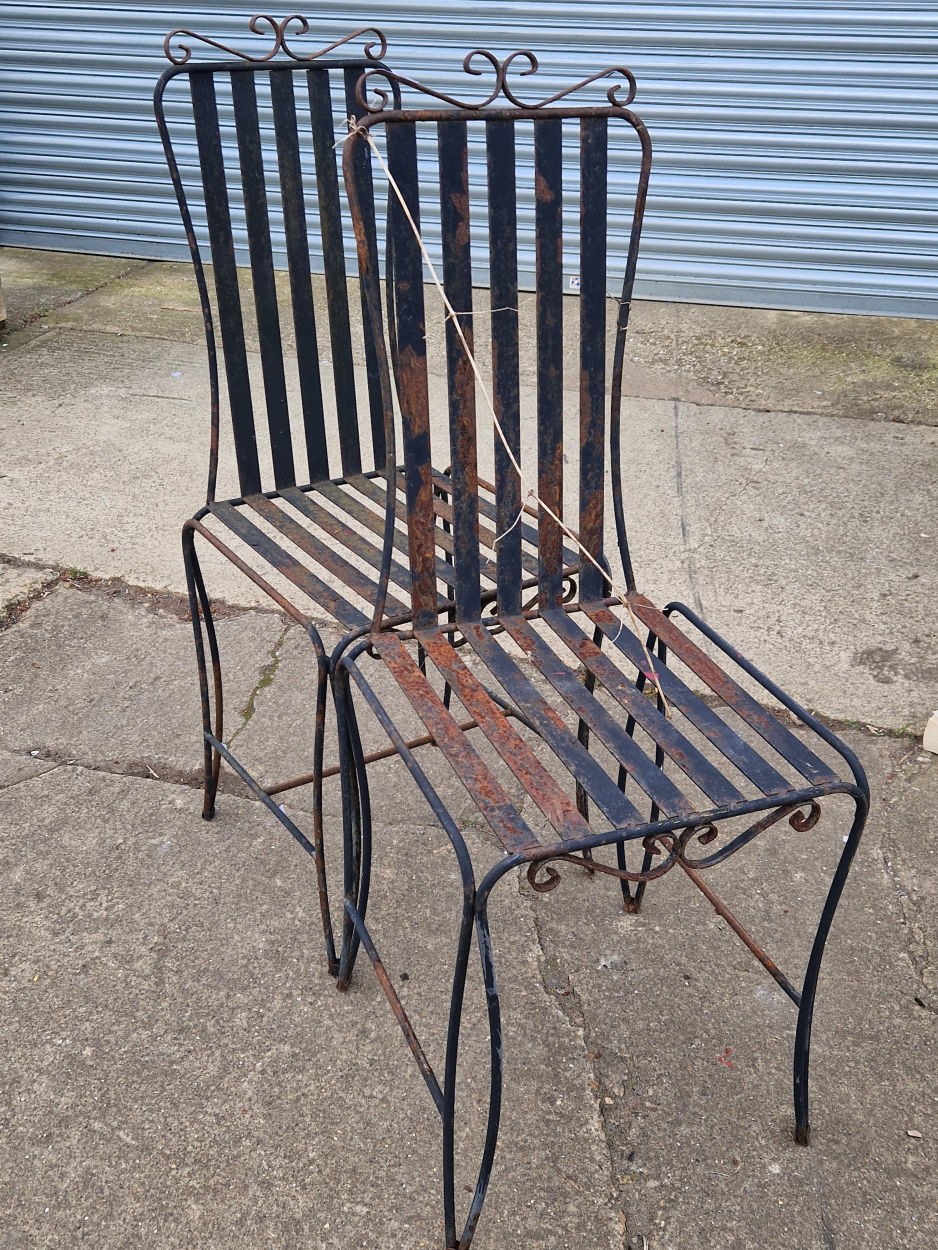 A SET OF FOUR WROUGHT IRON PATIO CHAIRS.