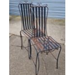 A SET OF FOUR WROUGHT IRON PATIO CHAIRS.