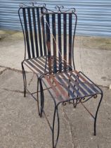 A SET OF FOUR WROUGHT IRON PATIO CHAIRS.