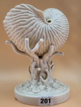 A LATE 19th C. BELLEEK PORCELAIN NAUTILUS SHELL RAISED ON A CORAL COLUMN FROM A SHELL STREWN