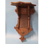 A PAIR OF ISLAMIC MAHOGANY WALL BRACKETS, THE STAR SHAPED SHELVES ABOVE BRACKETS INLAID WITH