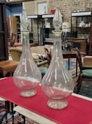 A PAIR OF PHARMACY SHOP GLASS BOTTLES AND SPIRE SHAPED STOPPER WITH COLOUR MIXES FOR FILLING THEM
