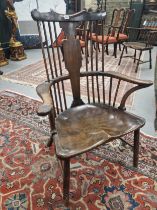 AN 18TH / 19TH CENTURY COUNTRY MADE WINDSOR TYPE CHAIR WITH SHAPED CREST RAIL AND BALUSTER BACK
