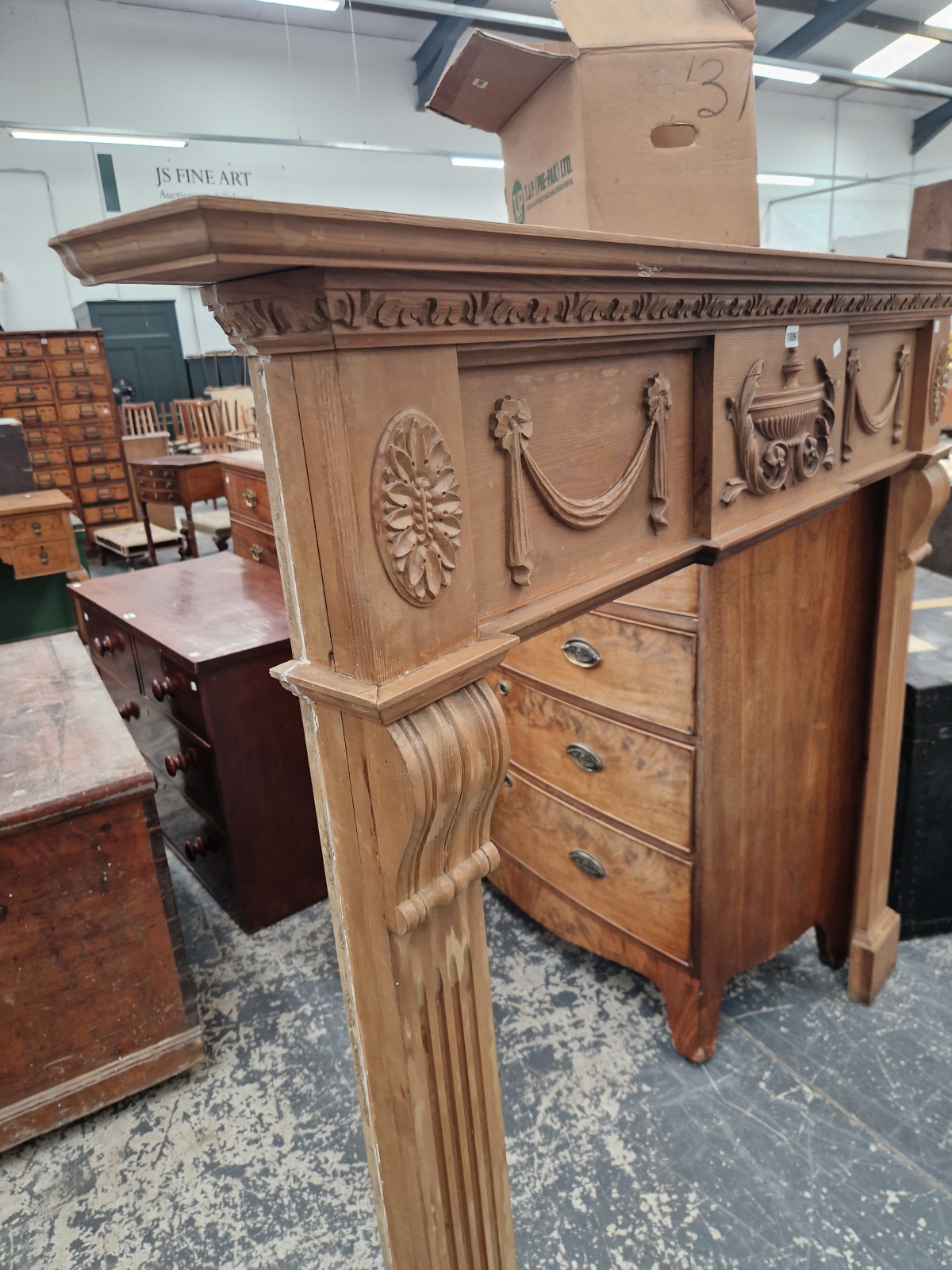 A REGENCY STYLE PINED FIRE SURROUND, THE FLUTED PILASTER SIDES CRESTED BY A CENTRAL URN FLANKED BY - Image 3 of 6