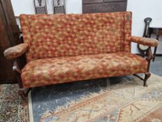 A MAHOGANY SETTEE, THE RECTANGULAR BACK, ARM RESTS AND SEAT UPHOLSTERED IN DIAMOND DIAPERED MATERIAL