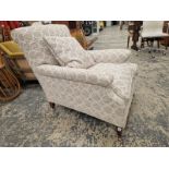 A HOWARD AND SONS ARMCHAIR UPHOLSTERED IN GREY CIRCLED MATERIAL, THE CASTER ON THE MAHOGANY BACK LEG