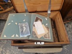 A STAINED PINE BOX WITH SILVERED IRON HANDLES AND CONTAINING LATE VICTORIAN PHOTOGRAPH ALBUMS AND