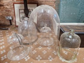 TWO CLEAR GLASS BELL SHAPED LIGHT SHADES, TWO DOME SHAPED CEILING BOWLS TOGETHER WITH A GLASS DOME