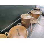 A COLLECTION OF COPPER POTS AND PANS, MOSTLY WITH LIDS