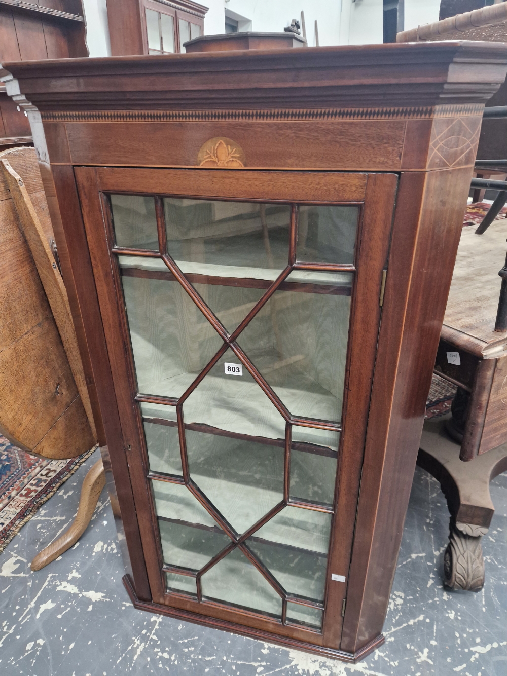 AN ANTIQUE MAHOGANY CORNER CUPBOARD WITH AN EBONY DIAMOND ON SATIN WOOD BAND ABOVE THE GLAZED DOOR