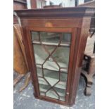 AN ANTIQUE MAHOGANY CORNER CUPBOARD WITH AN EBONY DIAMOND ON SATIN WOOD BAND ABOVE THE GLAZED DOOR