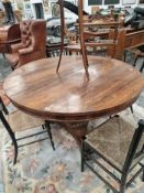 A 19th C. ROSEWOOD BREAKFAST TABLE ON AN OCTAGONAL COLUMN TRIPARTITE PLINTH AND SCROLL FEET. Dia.
