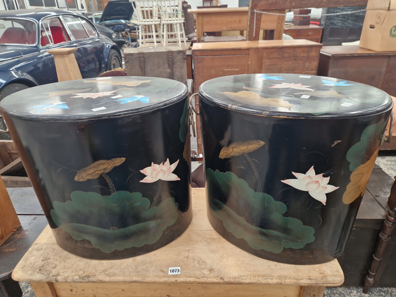A PAIR OF CHINESE BLACK LACQUER OVAL BOXES AND COVERS PAINTED WITH BLUE BIRDS AND LOTUS