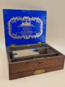 A VICTORIAN WINSOR & NEWTON MAHOGANY PAINT BOX WITH COMPARTMENTS ABOVE A DRAWER CONTAINING CERAMIC