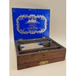 A VICTORIAN WINSOR & NEWTON MAHOGANY PAINT BOX WITH COMPARTMENTS ABOVE A DRAWER CONTAINING CERAMIC