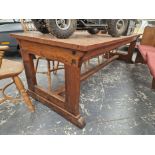 A TEAK AND PINE REFECTORY TABLE WITH A CLEATED PLANK TOP AND ON PAIRS OF LEGS TO EACH NARROW