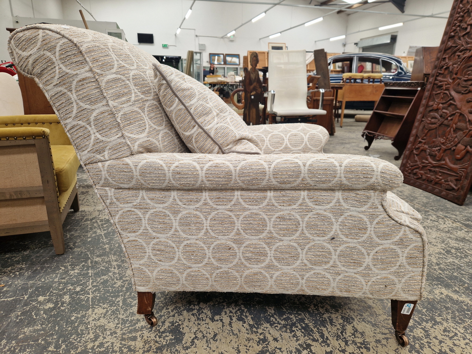 A HOWARD AND SONS ARMCHAIR UPHOLSTERED IN GREY CIRCLED MATERIAL, THE CASTER ON THE MAHOGANY BACK LEG - Image 2 of 12