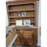 A RUSTIC PINE DRESSER WITH INTEGRAL PLATE RACK.