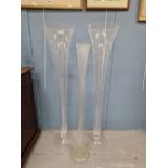 A PAIR OF CLEAR GLASS TRUMPET SHAPED VASES. H 120cms. TOGETHER WITH A SINGLE CLEAR GLASS VASE. H