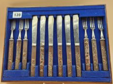 A TRAY OF SIX FRUIT KNIVES AND FORKS, EACH WITH PARCEL GILT COPPER JAPANESE KOZUKA HANDLES