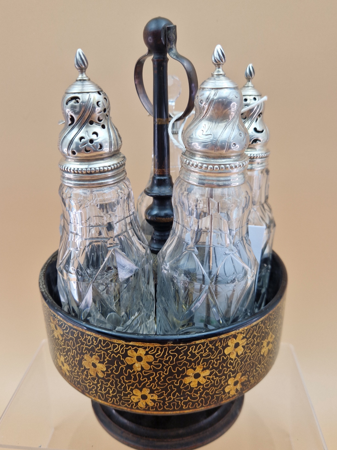 A FLORAL GILT BLACK PAPIER MACHE CRUET STAND WITH FIVE CUT GLASS BOTTLES WITH WHITE METAL MOUNTS, - Image 2 of 8