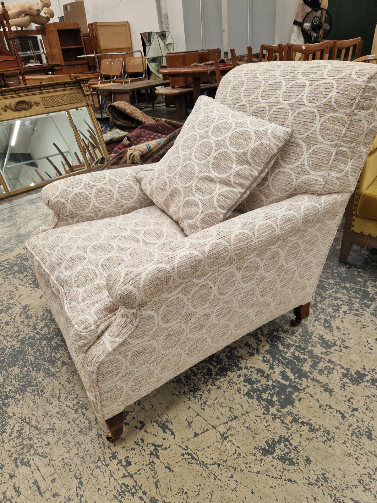 A HOWARD AND SONS ARMCHAIR UPHOLSTERED IN GREY CIRCLED MATERIAL, THE CASTER ON THE MAHOGANY BACK LEG - Image 6 of 12