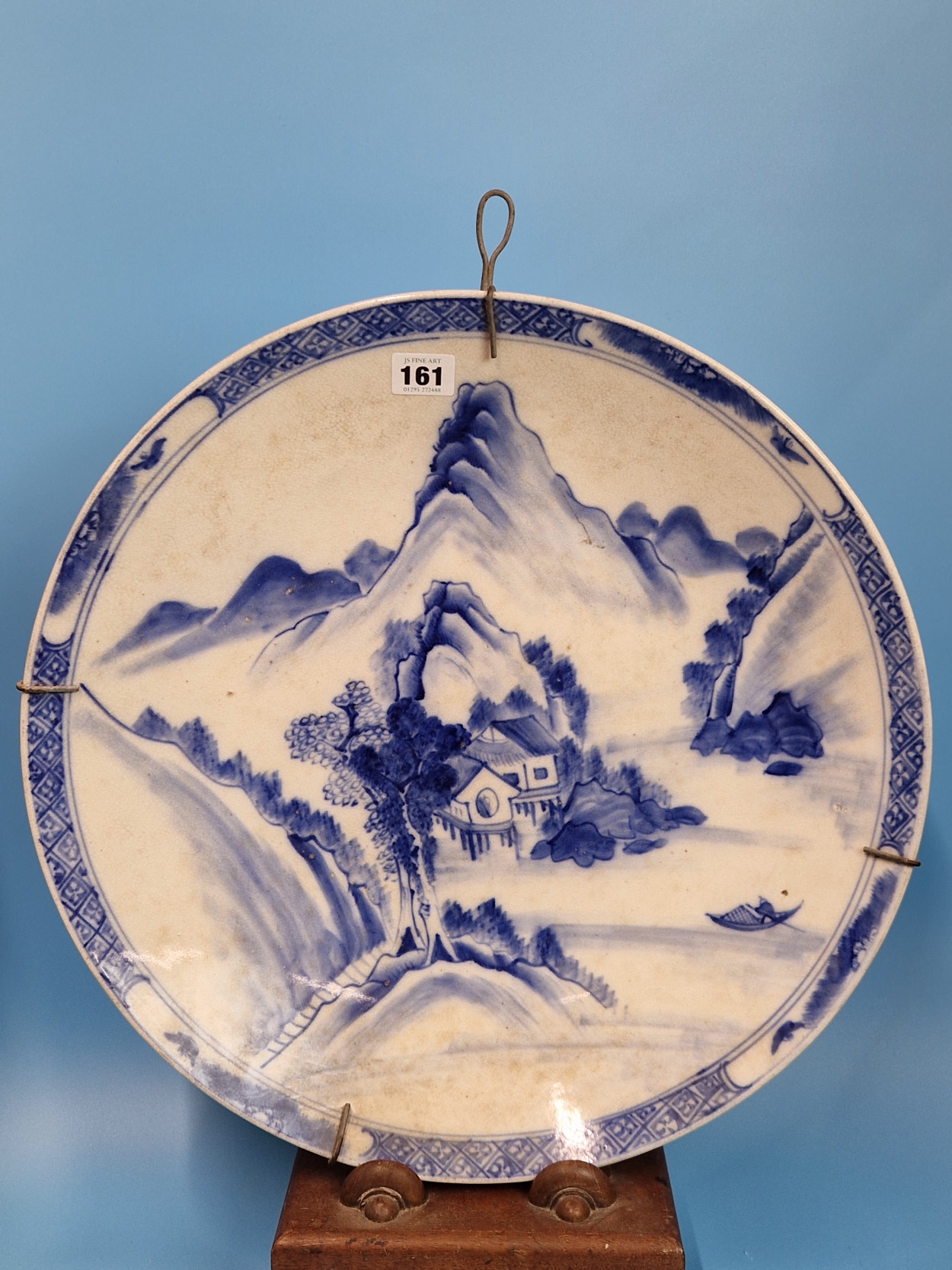 TWO CHINESE POTTERY BLUE AND WHITE CHARGERS, ONE PAINTED WITH A BIRD PERCHED ON A CHERRY BLOSSOM