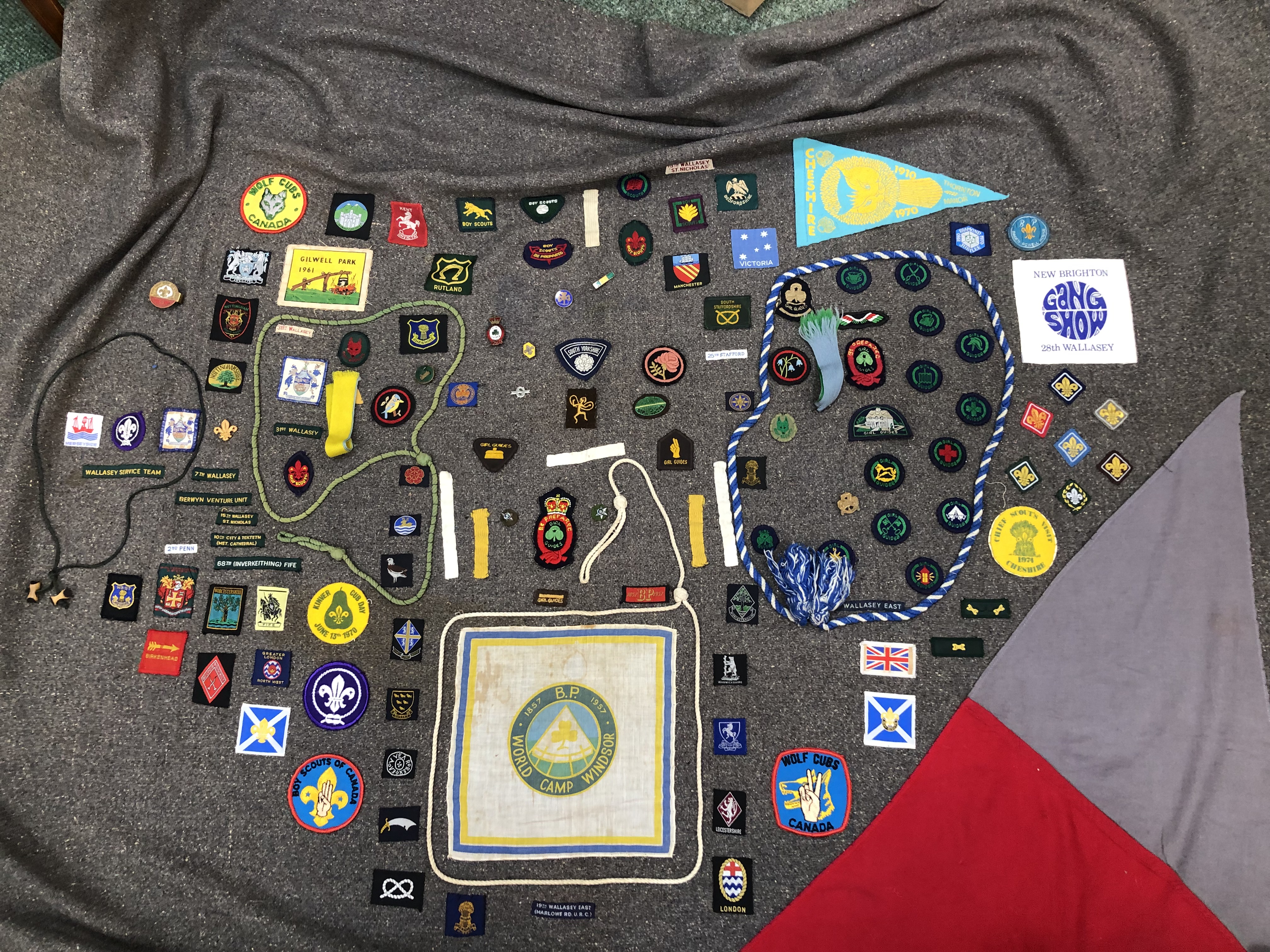 A GIRL GUIDE BLANKET WITH VINTAGE BADGES AND MEMORABILIA