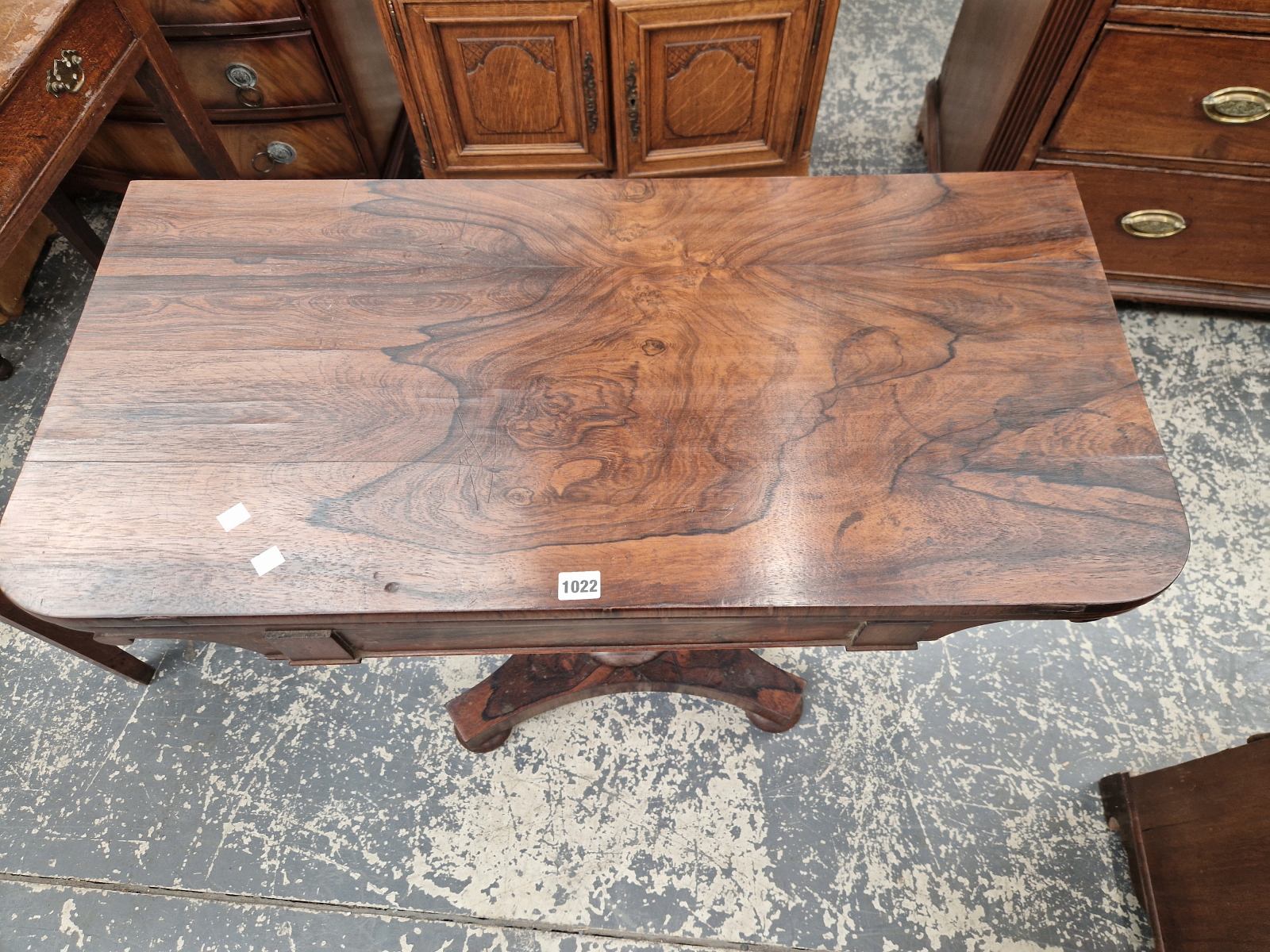 A 19th C. ROSEWOOD SWIVEL TOP GAMES TABLE ON A GUN BARREL COLUMN, QUADRIPARTITE PLINTH AND FOUR - Image 3 of 5