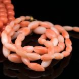 TWO VINTAGE ROWS OF CORAL BEADS. THE FIRST ROW WITH BARREL CLASP, AVERAGE BEAD SIZE 4.9mm,