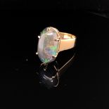 A 9ct HALLMARKED GOLD VINTAGE NATURAL OPAL SINGLE STONE RING. THE LARGE OVAL OPAL IN A RAISED SIX