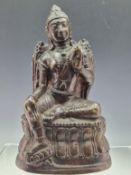 A BRONZE FIGURE IN DHYANASANA, POSSIBLY LORD VISHNU, SEATED WITH HIS RIGHT FOOT RESTING ON THE