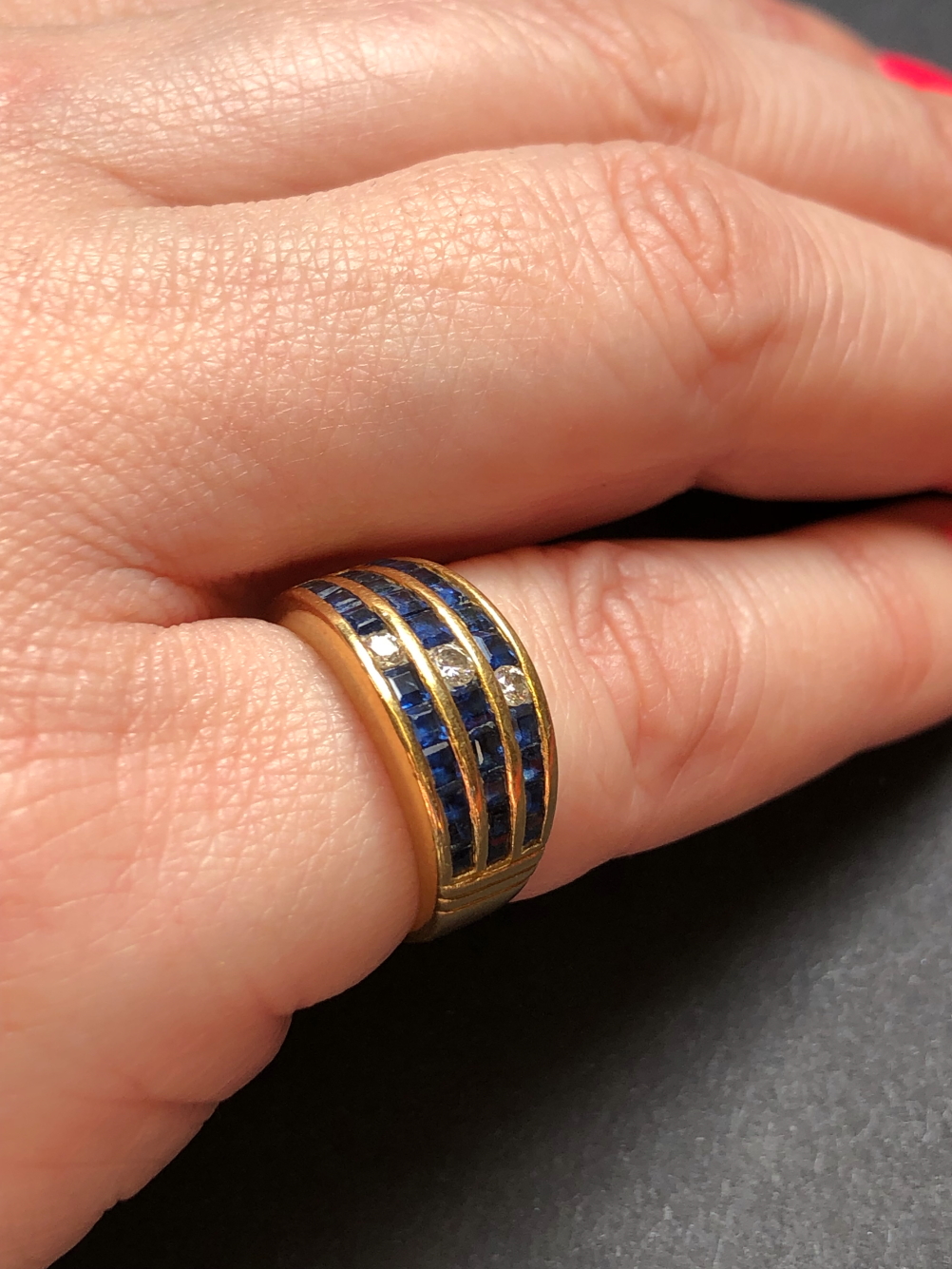 A SAPPHIRE AND DIAMOND THREE ROW CHANNEL SET HALF HOOP RING. UNHALLMARKED, ASSESSED AS 18ct GOLD. - Image 6 of 7