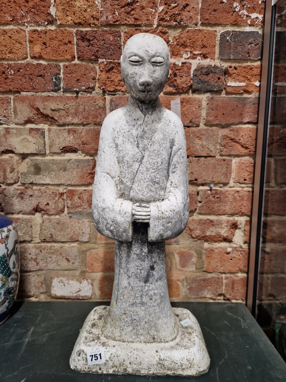 A COMPOSITION FIGURE OF A CHINESE MONK STANDING WITH HHIS HANDS CLASPED AT HIS WAIST. H 57cms.