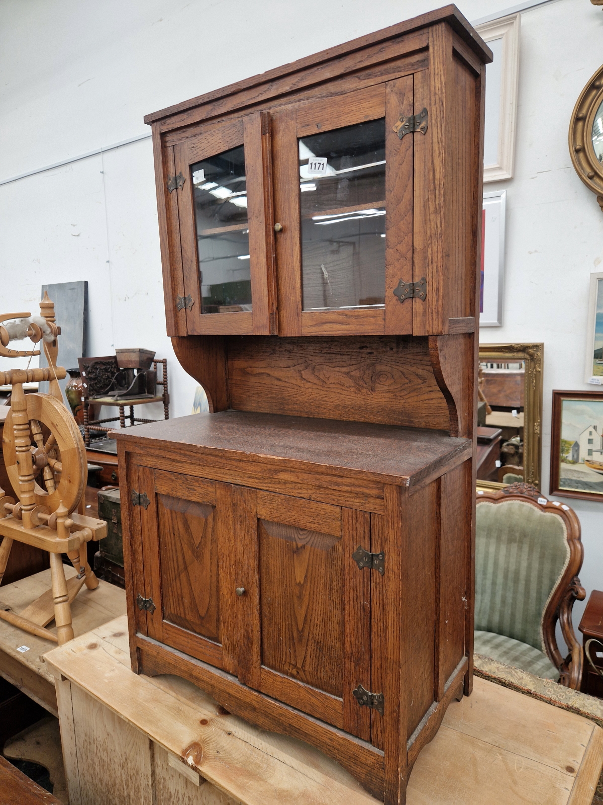 AN ARTS AND CRAFTS MINIATURE OAK GLAZED TOP DRESSER.