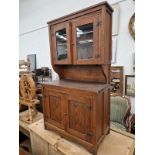 AN ARTS AND CRAFTS MINIATURE OAK GLAZED TOP DRESSER.