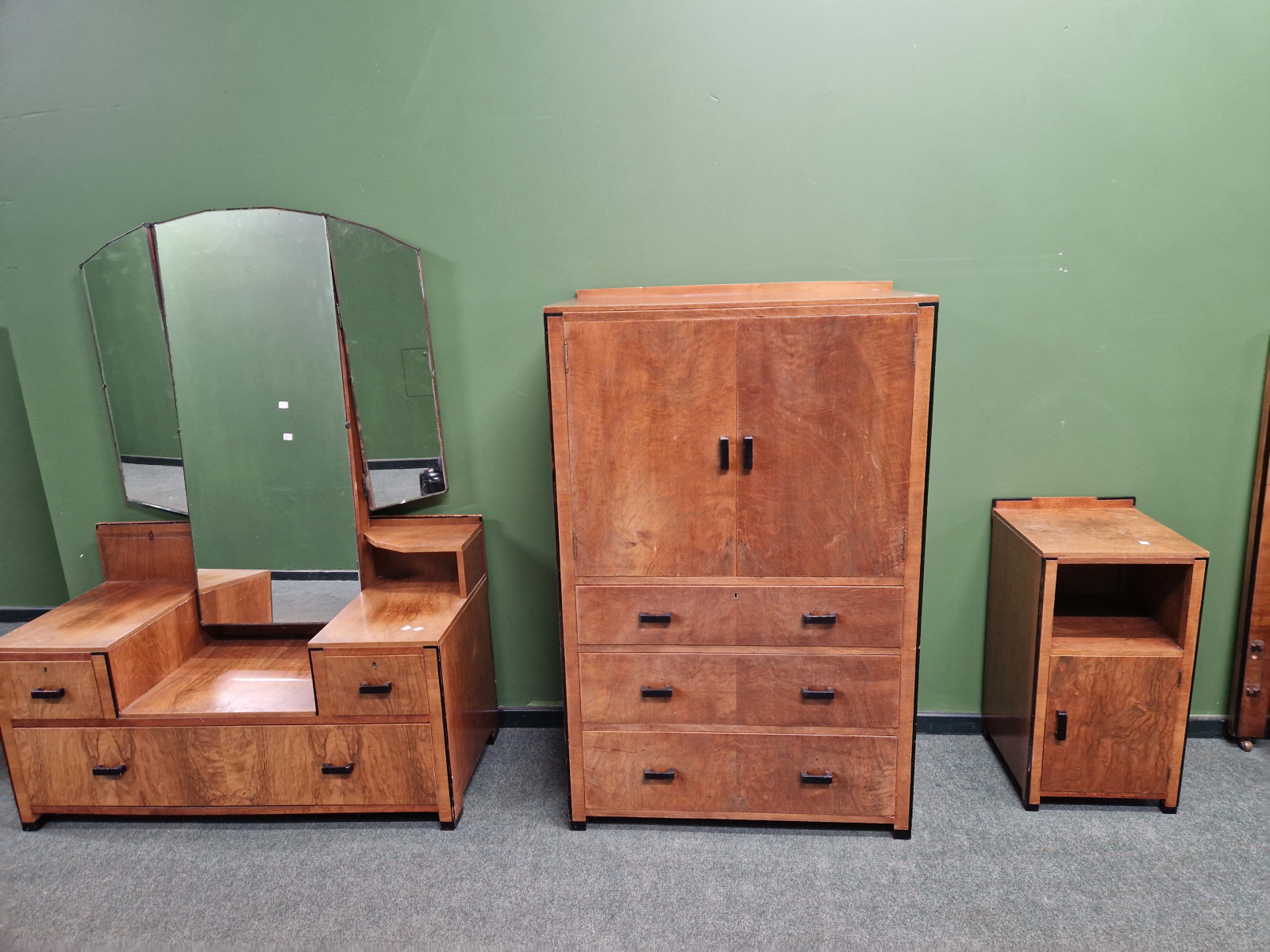 AN ART DECO WALNUT AND EBONISED BEDROOM SUITE COMPRISING LARGE TRIPLE WARDROBE, A TALLBOY, A LOW