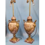 A PAIR OF ORMOLU MOUNTED MOTTLED PINK MARBLE TWO HANDLED BALUSTER LAMPS, EACH WITH TWO SOCKETS AND