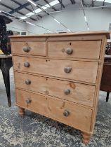 A VICTORIAN PINE CHEST OF TWO SHORT AND THREE GRADED LONG DRAWERS ON SHORT BALUSTER TURNED LEGS