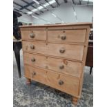 A VICTORIAN PINE CHEST OF TWO SHORT AND THREE GRADED LONG DRAWERS ON SHORT BALUSTER TURNED LEGS