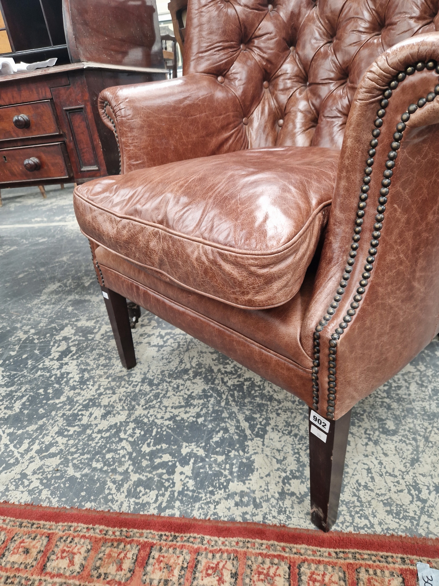 A MAHOGANY WING ARMCHAIR BUTTON UPHOLSTERED IN BROWN LEATHERETTE, CLOSE NAILING RUNNING FROM THE - Image 3 of 5