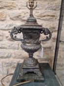 A PAIR OF BRONZE TWO HANDLED URN FORM TABLE LAMPS SUPPORTED ON SQUARE SERPENTINITE PLINTHS. H