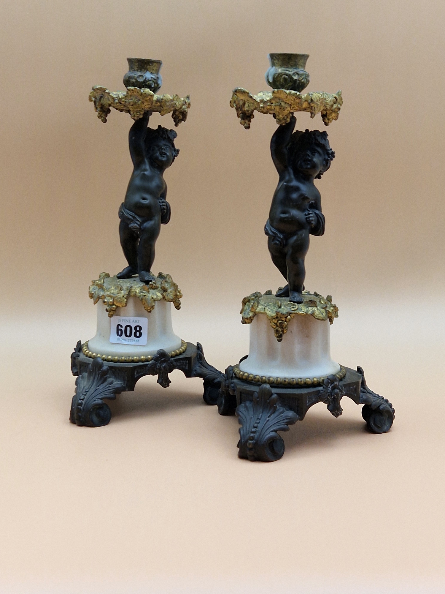 A PAIR OF LATE 19th C. BRONZE, ORMOLU AND WHITE MARBLE CANDLESTICKS HELD UP BY PUTTI STANDING ON - Image 5 of 5