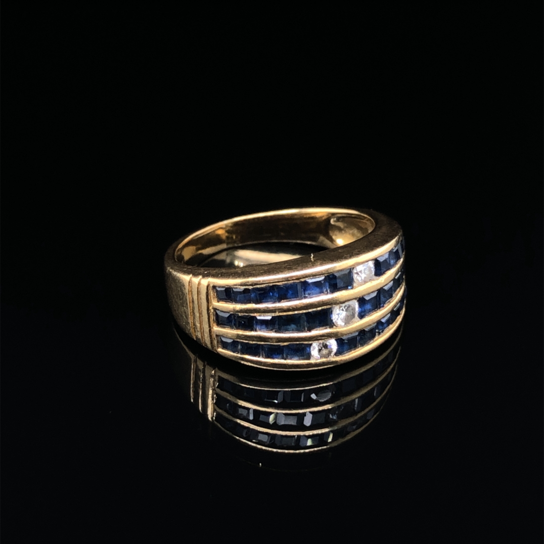 A SAPPHIRE AND DIAMOND THREE ROW CHANNEL SET HALF HOOP RING. UNHALLMARKED, ASSESSED AS 18ct GOLD. - Image 3 of 7