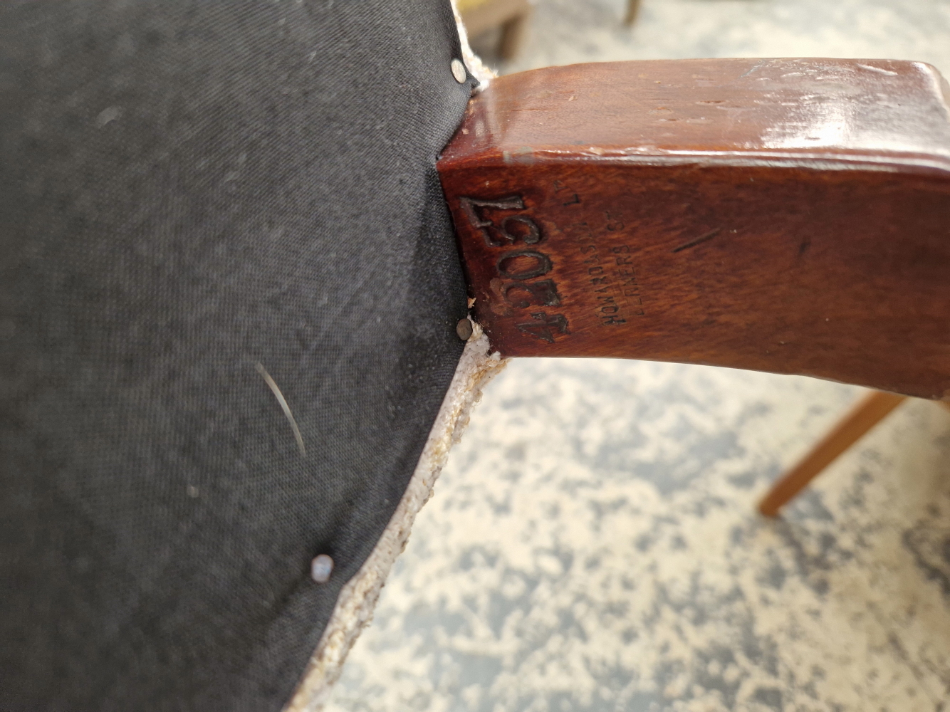 A HOWARD AND SONS ARMCHAIR UPHOLSTERED IN GREY CIRCLED MATERIAL, THE CASTER ON THE MAHOGANY BACK LEG - Image 11 of 12