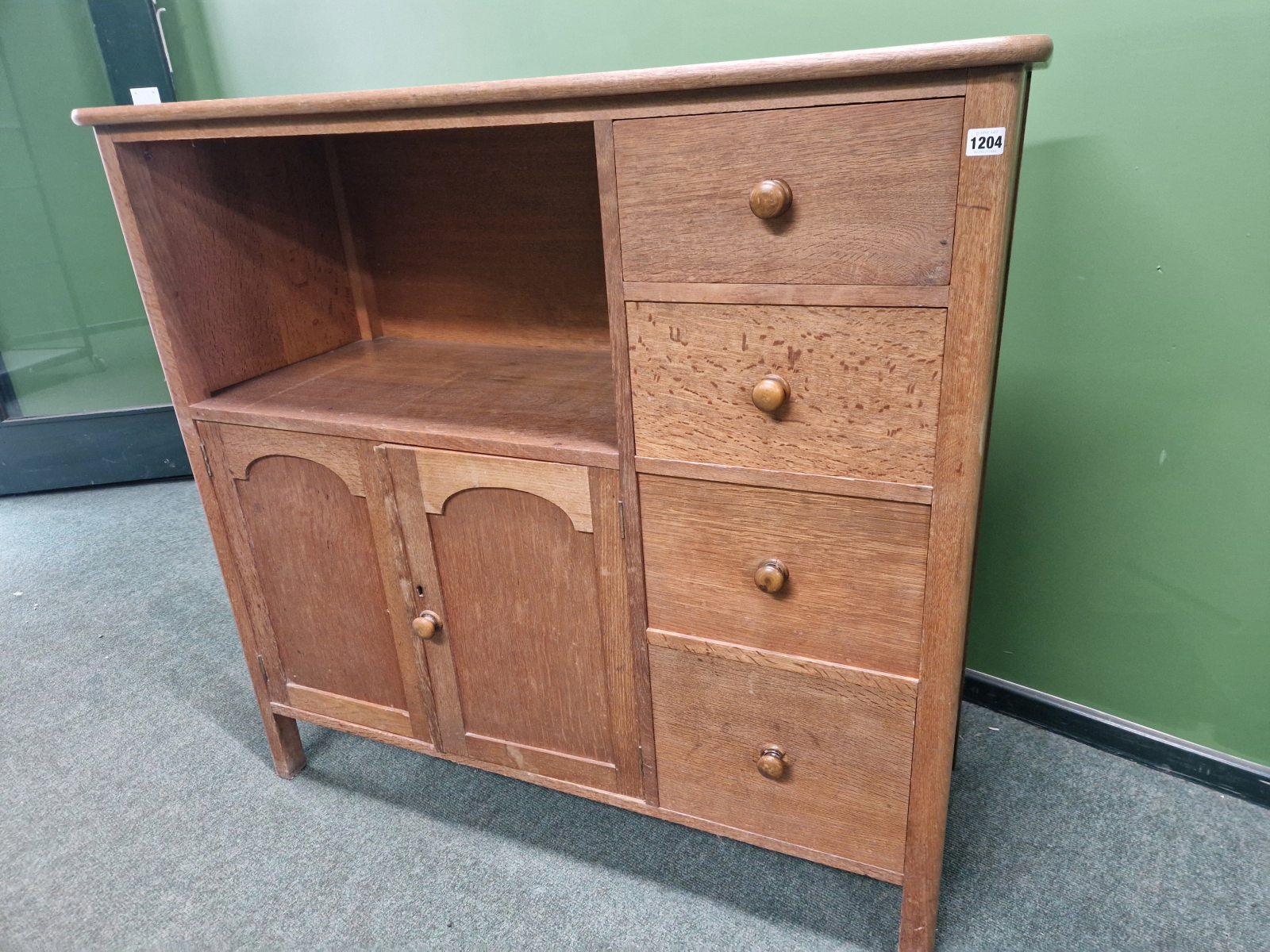 AN ARTS AND CRAFTS STYLE OAK SIDE CABINET IN THE MANNER OF HEALS.
