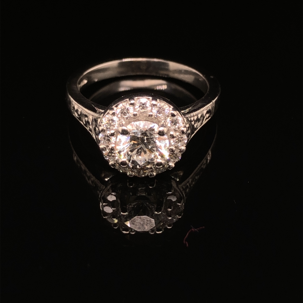 A GIA ROUND BRILLIANT CUT DIAMOND AND PLATINUM RING. THE CENTRE DIAMOND 0.71cts, SURROUNDED BY A - Image 9 of 10