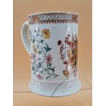 A CHINESE ARMORIAL QUART MUG WITH THE ARMS PAINTED OPPOSITE THE HANDLE AND FLANKED BY FAMILLE ROSE